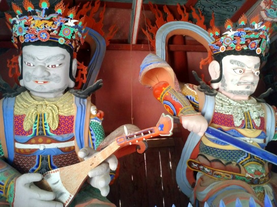 Two imposing guardians inside the Geumgangmun Gate at Hwaeomsa Temple.